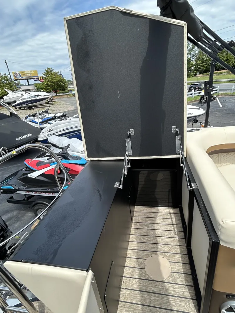 Slide: The Image of 2022 Lowe 190 SS boat storage compartment open, showcasing interior space and deck. - 9