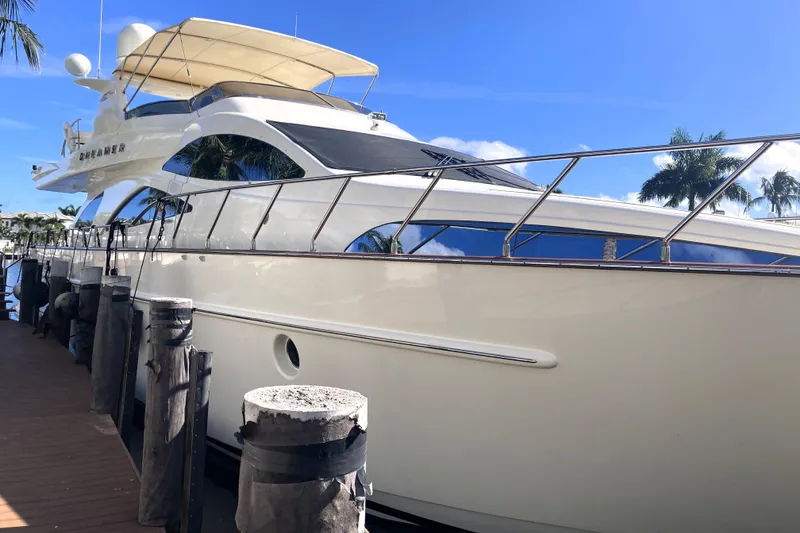 Slide: The Image of Luxury 2005 Azimut 80 Carat yacht docked under clear blue sky. - 128