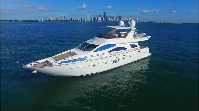 Slide: The Image of Luxury 2005 Azimut 80 Carat yacht cruising near city skyline on a sunny day. - 13