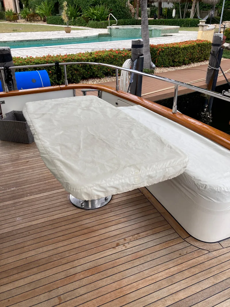Slide: The Image of 2005 Azimut 80 Carat yacht interior with open storage compartment and wooden flooring. - 24