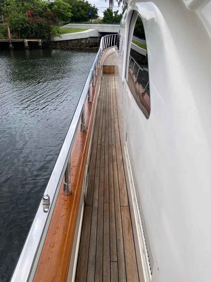 Slide: The Image of 2005 Azimut 80 Carat yacht deck with covered table and seating area. - 25