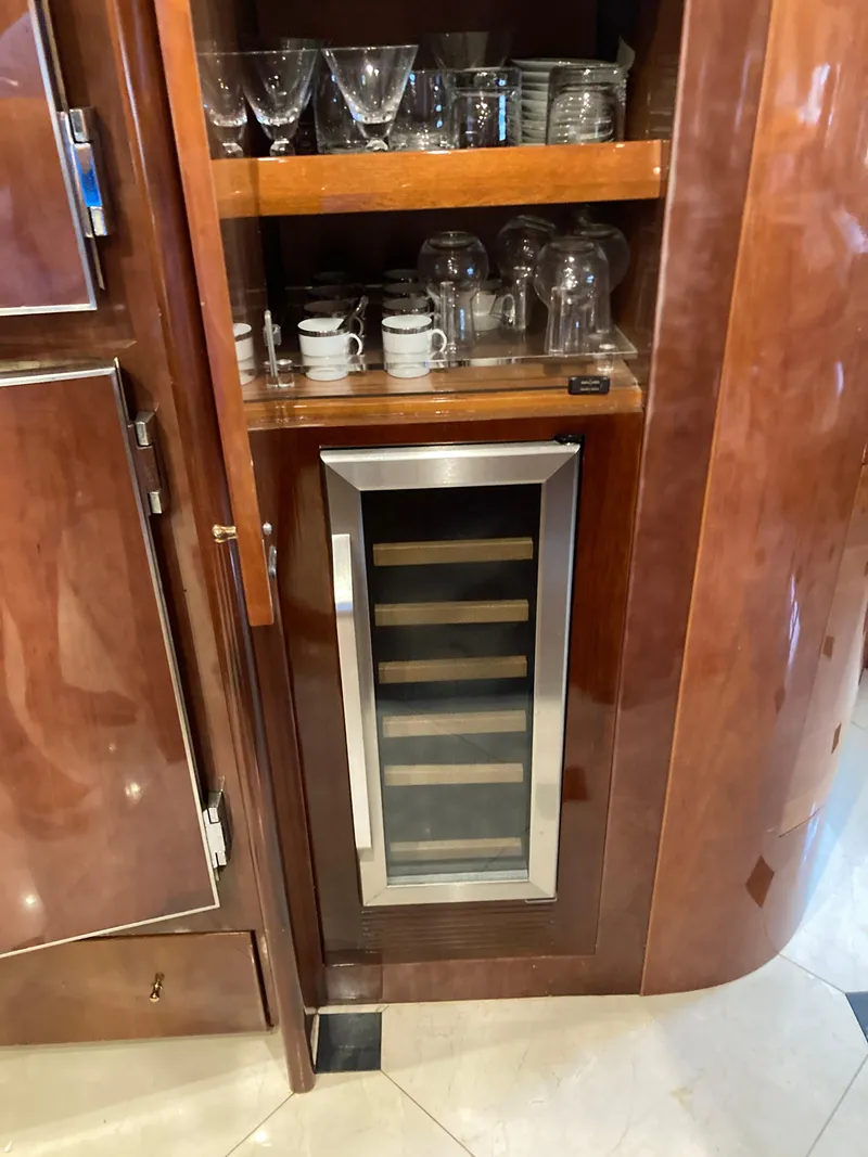 Slide: The Image of Narrow kitchen space on 2005 Azimut 80 Carat yacht with wood cabinets and tiled floor. - 49