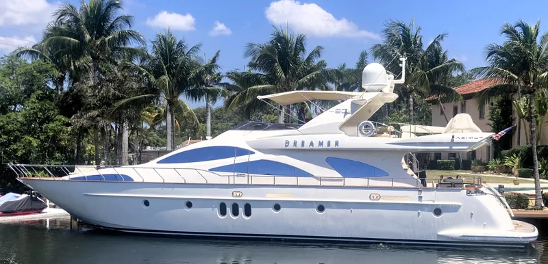 Slide: The Image of Luxury 2005 Azimut 80 Carat yacht docked, surrounded by palm trees and clear skies. - 5