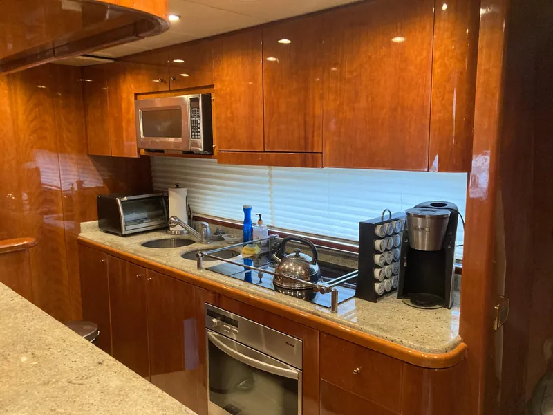Slide: The Image of Wooden kitchen cabinets with open doors on a 2005 Azimut 80 Carat yacht. - 50