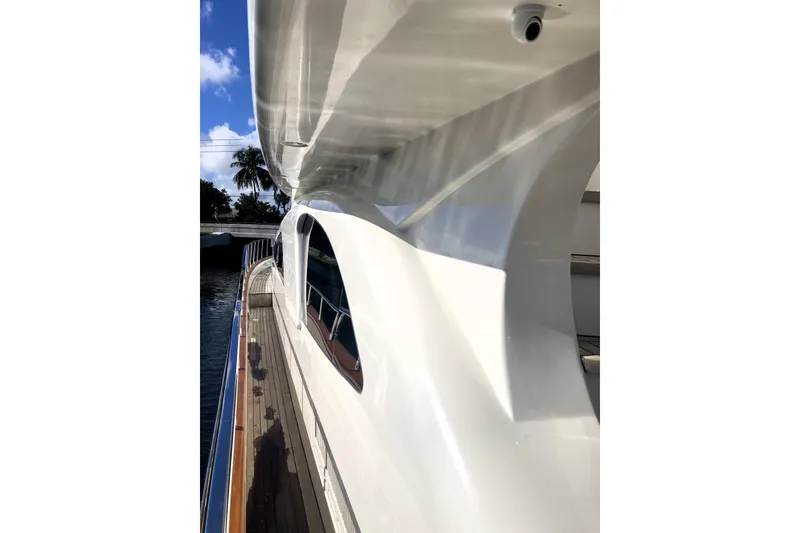 Slide: The Image of Side view of 2005 Azimut 80 Carat yacht, showcasing sleek design and wooden deck. - 130