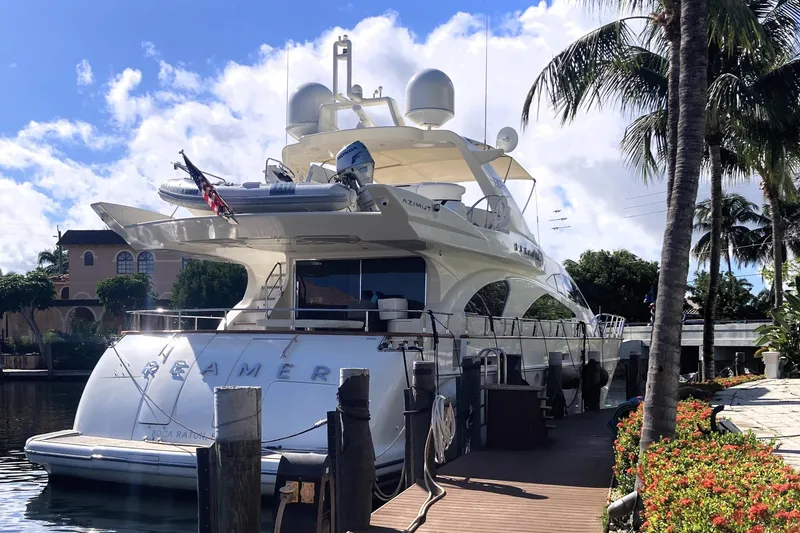 Slide: The Image of Luxury 2005 Azimut 80 Carat yacht docked by palm trees and waterfront homes. - 131