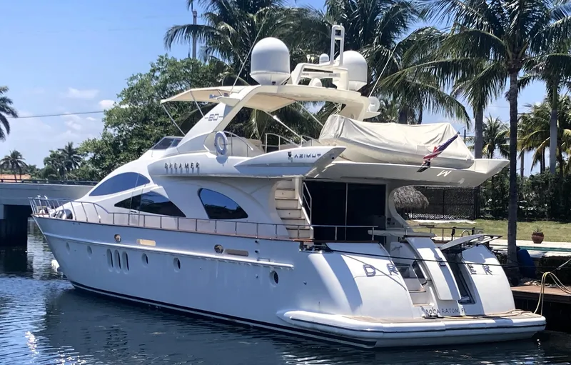 Slide: The Image of Luxury 2005 Azimut 80 Carat yacht docked by palm trees. - 2