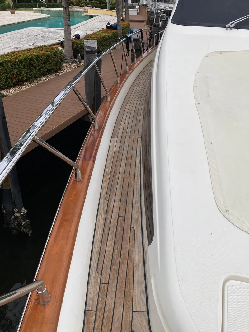 Slide: The Image of 2005 Azimut 80 Carat yacht deck with wooden flooring and sleek design. - 29