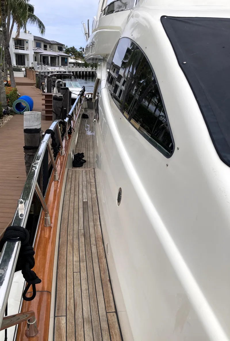 Slide: The Image of Side view of 2005 Azimut 80 Carat yacht docked at marina. - 30