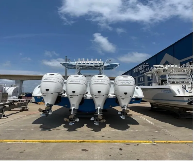 Slide: The Image of 2022 Yellowfin 39 Offshore boat with four powerful outboard engines, docked under a clear sky. - 11