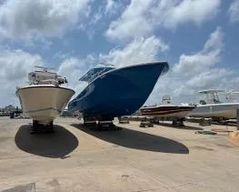 Slide: The Image of 2022 Yellowfin 39 Offshore boat on display under a cloudy sky. - 13