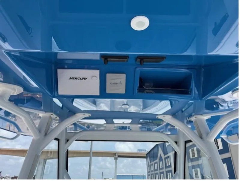 Slide: The Image of 2022 Yellowfin 39 Offshore boat interior with blue ceiling and electronic controls. - 14