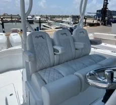 Slide: The Image of 2022 Yellowfin 39 Offshore boat with luxurious seating at a marina. - 17
