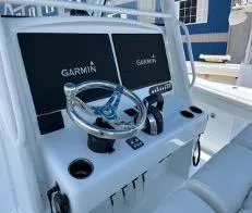 Slide: The Image of 2022 Yellowfin 39 Offshore boat dashboard with Garmin displays and steering wheel. - 20