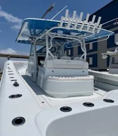 Slide: The Image of 2022 Yellowfin 39 Offshore boat with blue canopy and fishing rod holders. - 22