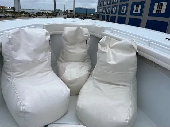 Slide: The Image of Three white bean bag chairs on a 2022 Yellowfin 39 Offshore boat deck. - 24