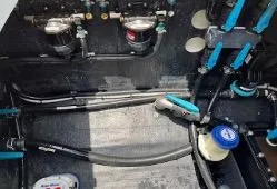 Slide: The Image of Engine compartment of a 2022 Yellowfin 39 Offshore boat, showcasing mechanical components and wiring. - 26