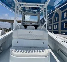 Slide: The Image of 2022 Yellowfin 39 Offshore boat interior with seating and blue canopy. - 29