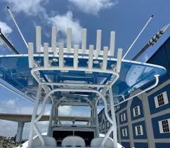 Slide: The Image of 2022 Yellowfin 39 Offshore boat with blue canopy and rod holders, under a clear sky. - 30
