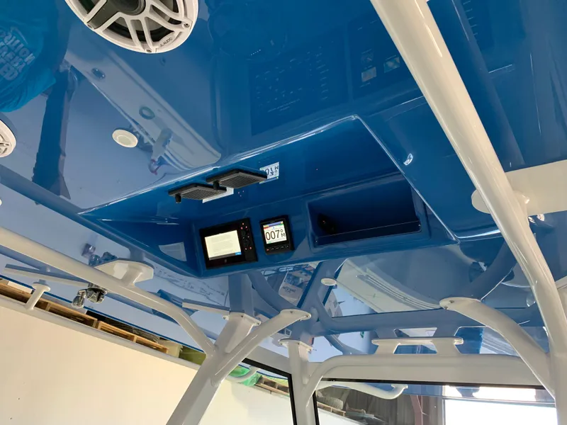 Slide: The Image of 2022 Yellowfin 39 Offshore boat interior with blue ceiling and electronic displays. - 9
