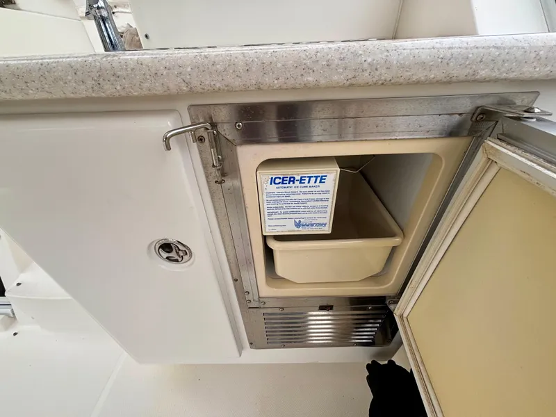 Slide: The Image of 2005 Silverton 39 Motor Yacht ice maker with open door, showcasing interior compartment. - 12