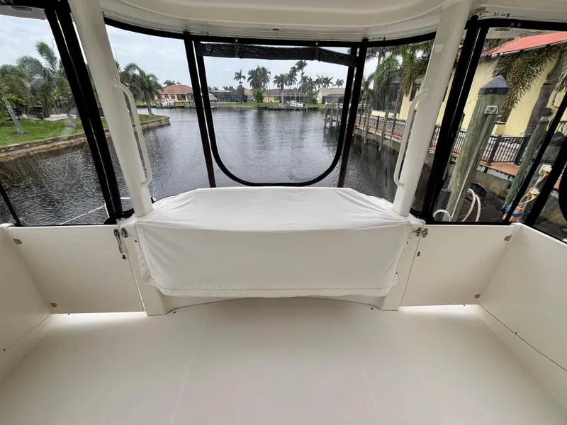 Slide: The Image of 2005 Silverton 39 Motor Yacht interior with waterfront view, featuring spacious seating and large windows. - 14