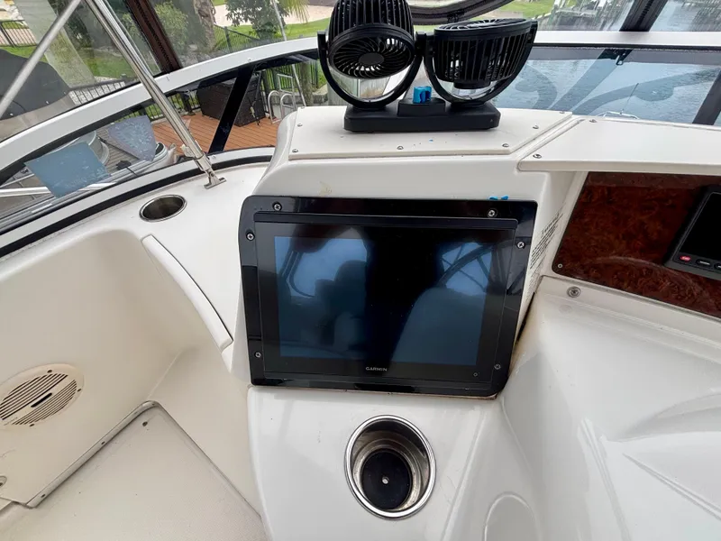 Slide: The Image of 2005 Silverton 39 Motor Yacht helm with navigation screen and dual fans. - 22