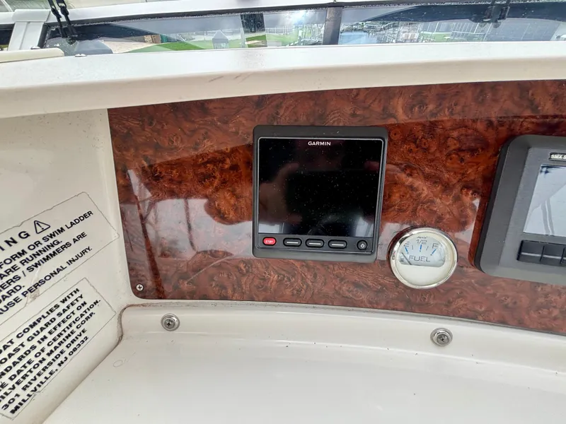 Slide: The Image of 2005 Silverton 39 Motor Yacht dashboard with Garmin display and fuel gauge. - 24