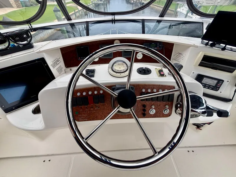 Slide: The Image of 2005 Silverton 39 Motor Yacht helm with steering wheel and control panel. - 29