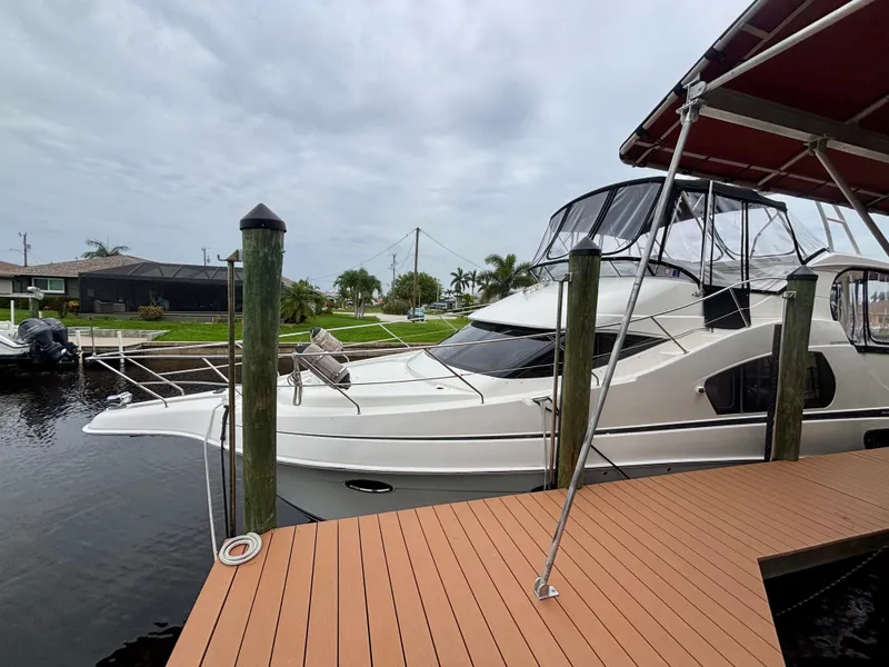 Slide: The Image of 2005 Silverton 39 Motor Yacht docked at marina under cloudy sky. - 3