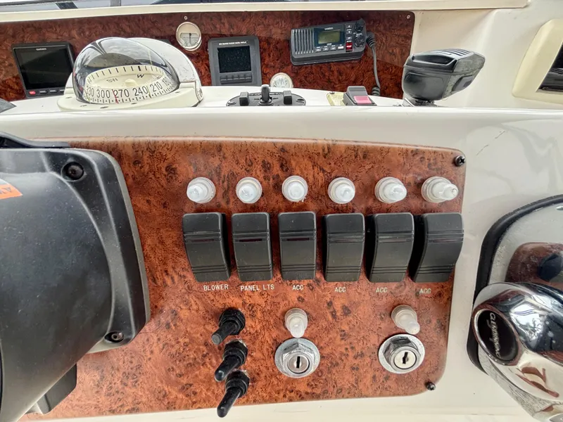 Slide: The Image of Control panel of a 2005 Silverton 39 Motor Yacht with switches and navigation instruments. - 31