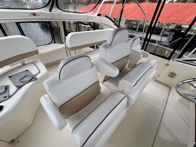 Slide: The Image of 2005 Silverton 39 Motor Yacht interior with white seating and panoramic windows. - 35