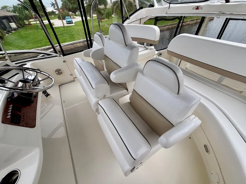 Slide: The Image of 2005 Silverton 39 Motor Yacht interior with white seating and helm station. - 37