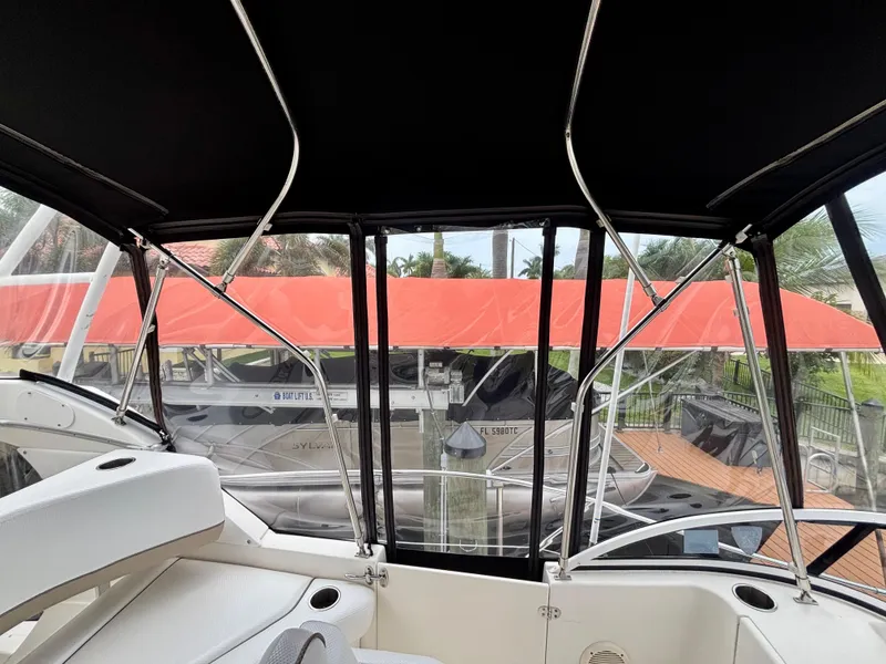 Slide: The Image of 2005 Silverton 39 Motor Yacht interior with black canopy and marina view. - 39