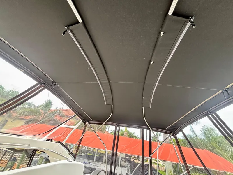 Slide: The Image of 2005 Silverton 39 Motor Yacht canopy with metal supports and clear side panels. - 40