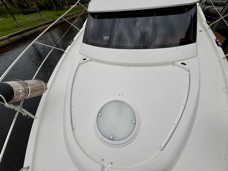 Slide: The Image of 2005 Silverton 39 Motor Yacht deck with circular hatch and sleek design. - 48