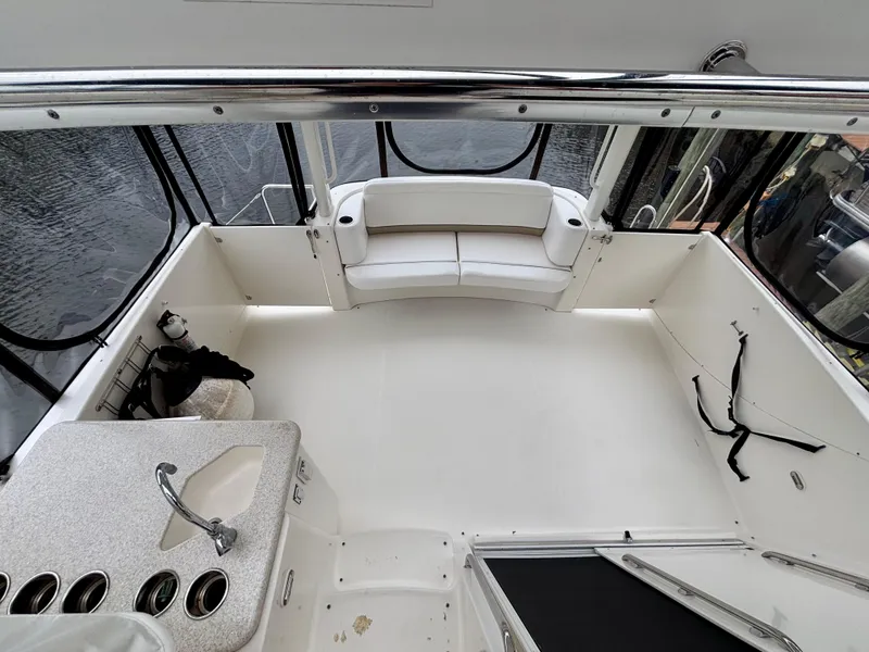 Slide: The Image of 2005 Silverton 39 Motor Yacht interior with seating and kitchenette, overlooking water. - 7