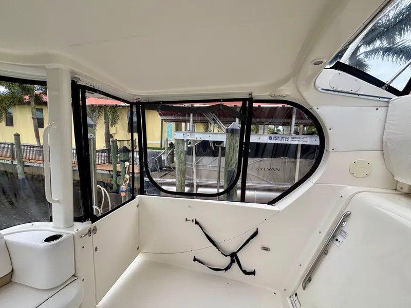 Slide: The Image of Interior view of a 2005 Silverton 39 Motor Yacht with large windows and white seating. - 9