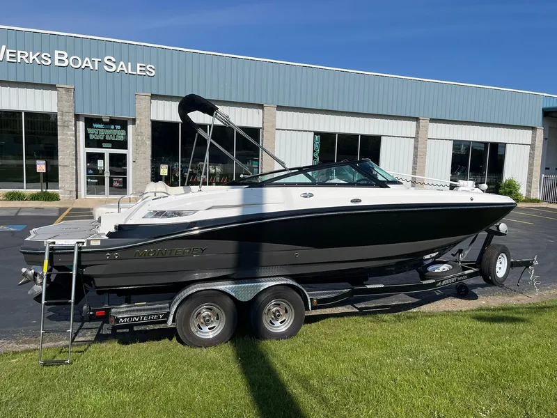 Slide: The Image of 2015 Monterey M4 boat on trailer outside dealership, sunny day. - 1