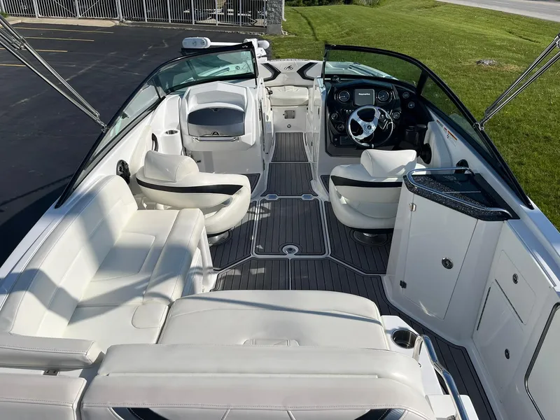 Slide: The Image of 2015 Monterey M4 boat interior with white seating and modern dashboard. - 10