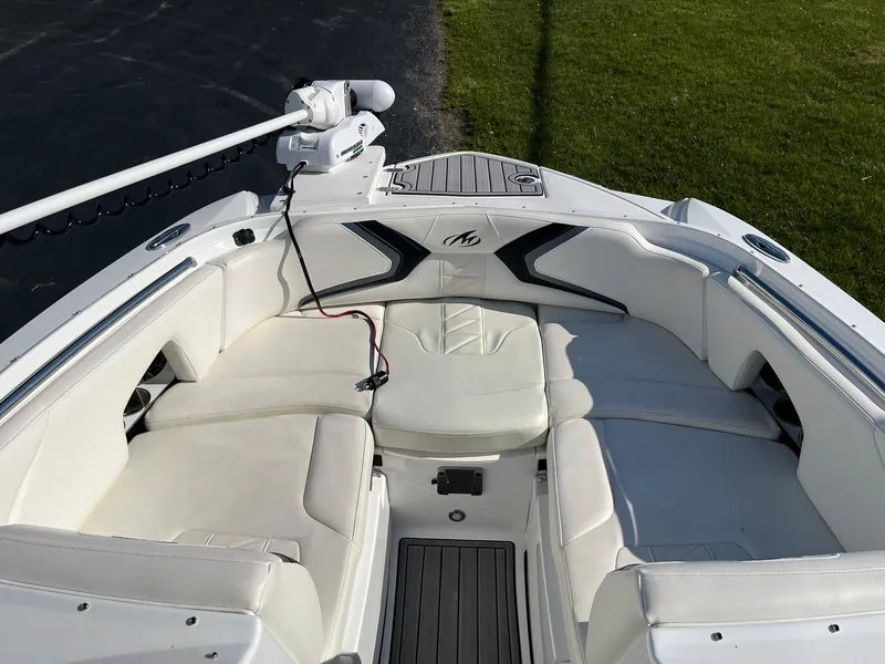 Slide: The Image of Bow seating area of a 2015 Monterey M4 boat with white upholstery and a trolling motor. - 11