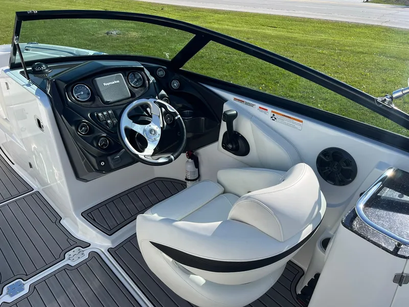 Slide: The Image of 2015 Monterey M4 boat cockpit with steering wheel, dashboard, and white captain's seat. - 13