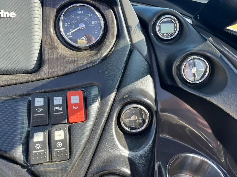 Slide: The Image of Dashboard of a 2015 Monterey M4 boat with gauges and control switches. - 16