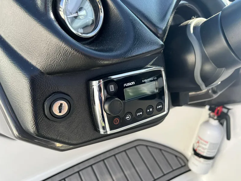 Slide: The Image of Dashboard of a 2015 Monterey M4 boat featuring a Fusion stereo system and fire extinguisher. - 17