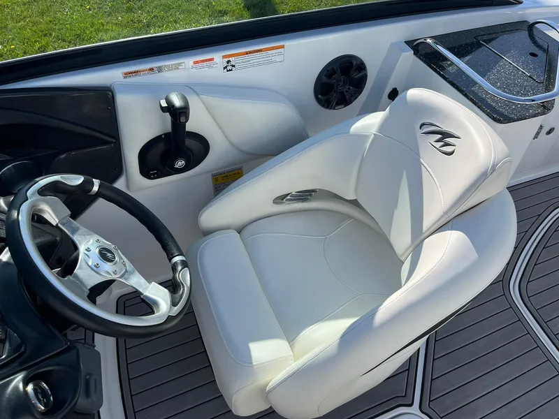 Slide: The Image of Interior of a 2015 Monterey M4 boat with white seating and steering wheel. - 18