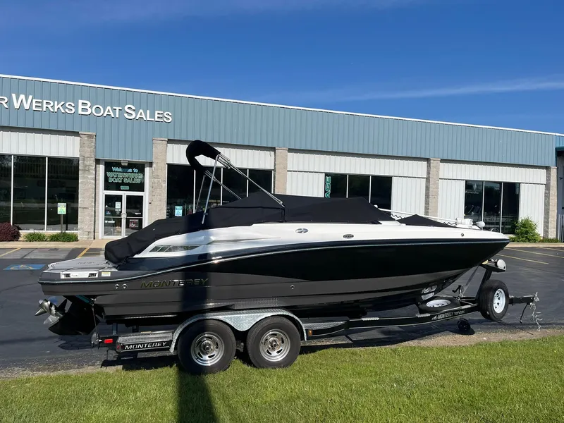 Slide: The Image of 2015 Monterey M4 boat on trailer outside dealership, sunny day. - 2
