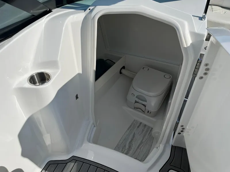 Slide: The Image of Compact bathroom in a 2015 Monterey M4 boat, featuring a toilet and modern design. - 20