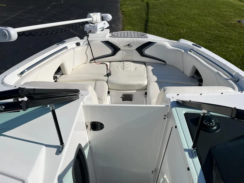 Slide: The Image of Bow seating area of a 2015 Monterey M4 boat with white upholstery. - 26