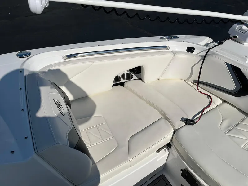 Slide: The Image of 2015 Monterey M4 boat interior with white cushioned seating and cup holders. - 27
