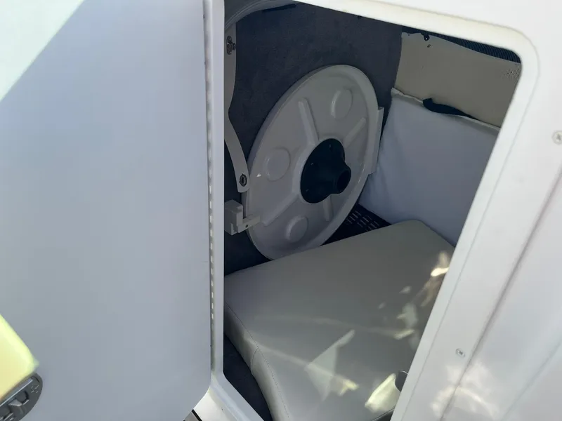 Slide: The Image of Storage compartment in a 2015 Monterey M4 boat, featuring a circular hatch and cushioned interior. - 28